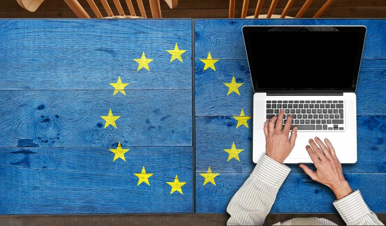 Europe flagged wooden table with laptop