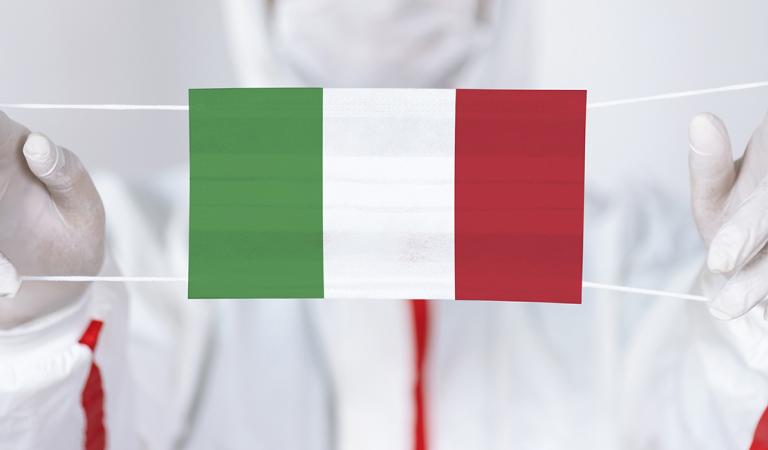 Healthcare personnel is holding Italian Flag shaped surgical mask