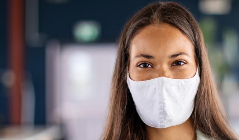 Portrait of a businesswoman with face mask in office