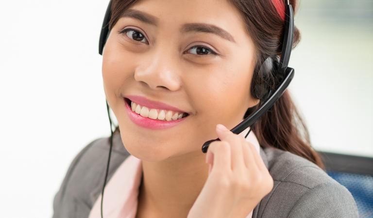 Portrait of lovely young Vietnamese helpdesk operator
